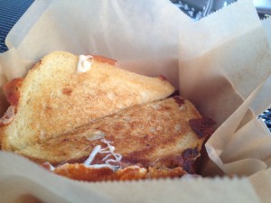 Look at that ear of fried cheese hanging off this delectable crab filled grilled cheese sammie